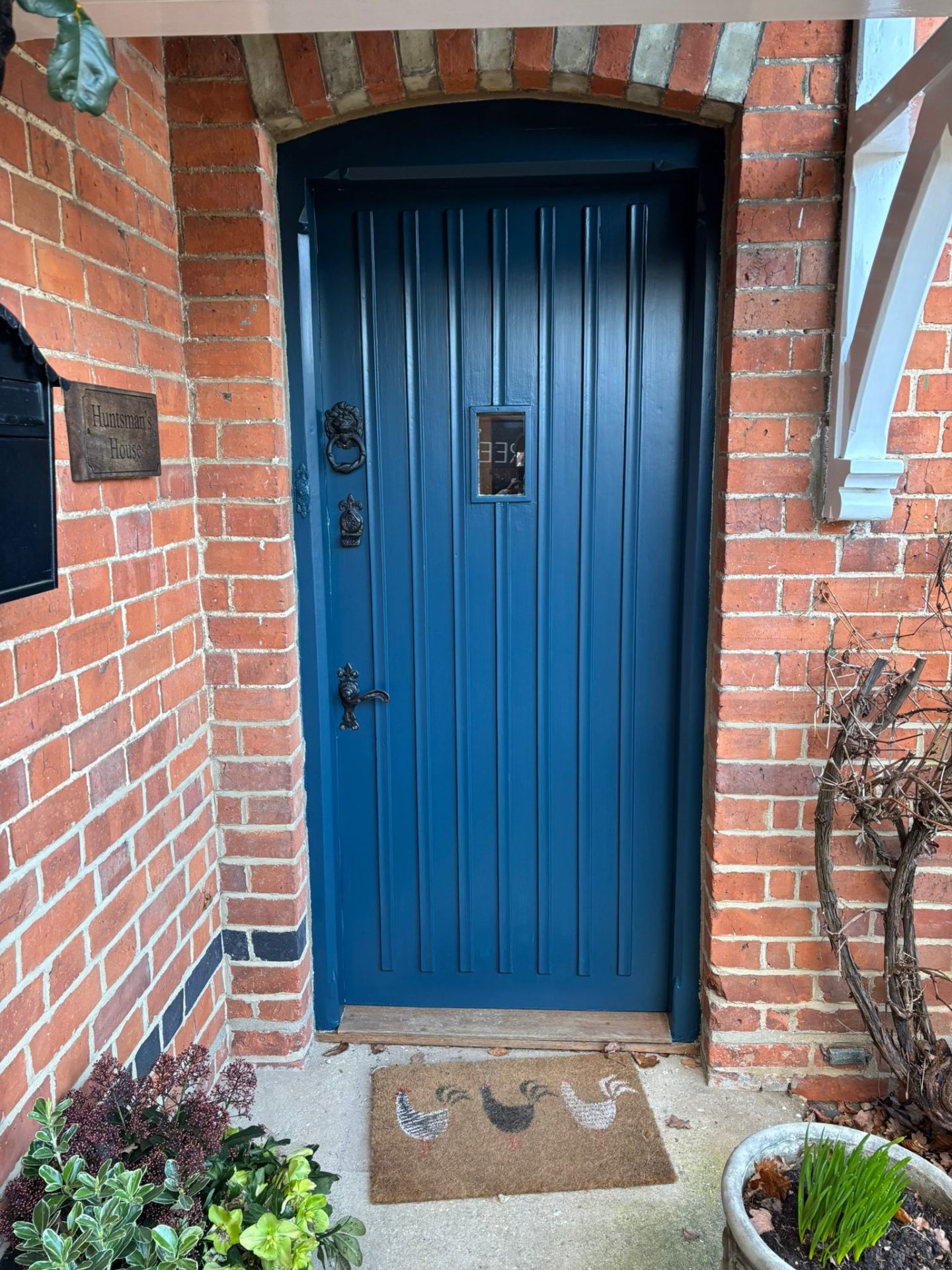 Freshly painted blue front door adding kerb appeal to a brick property
