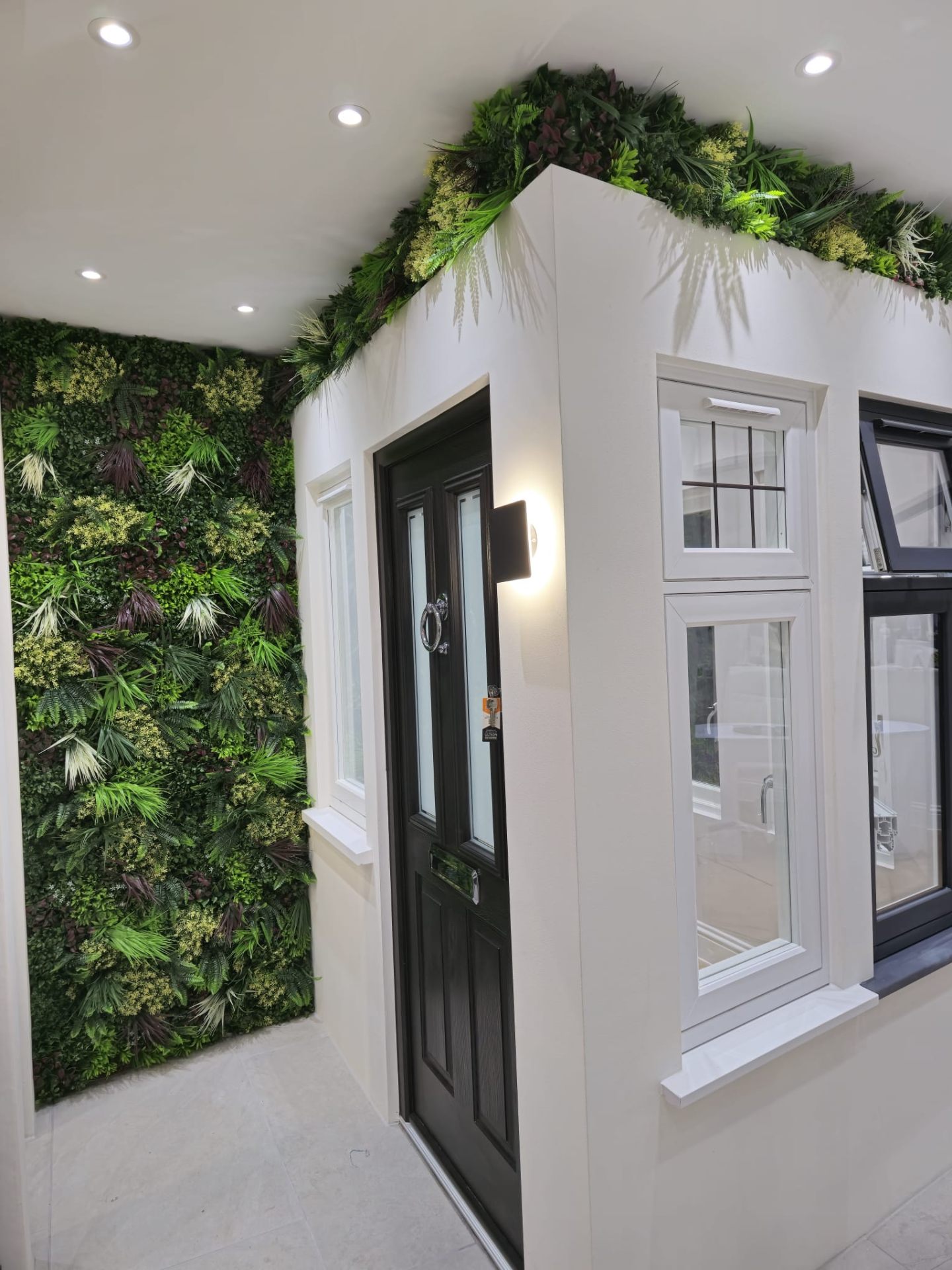 Property entrance with living green wall and freshly painted masonry