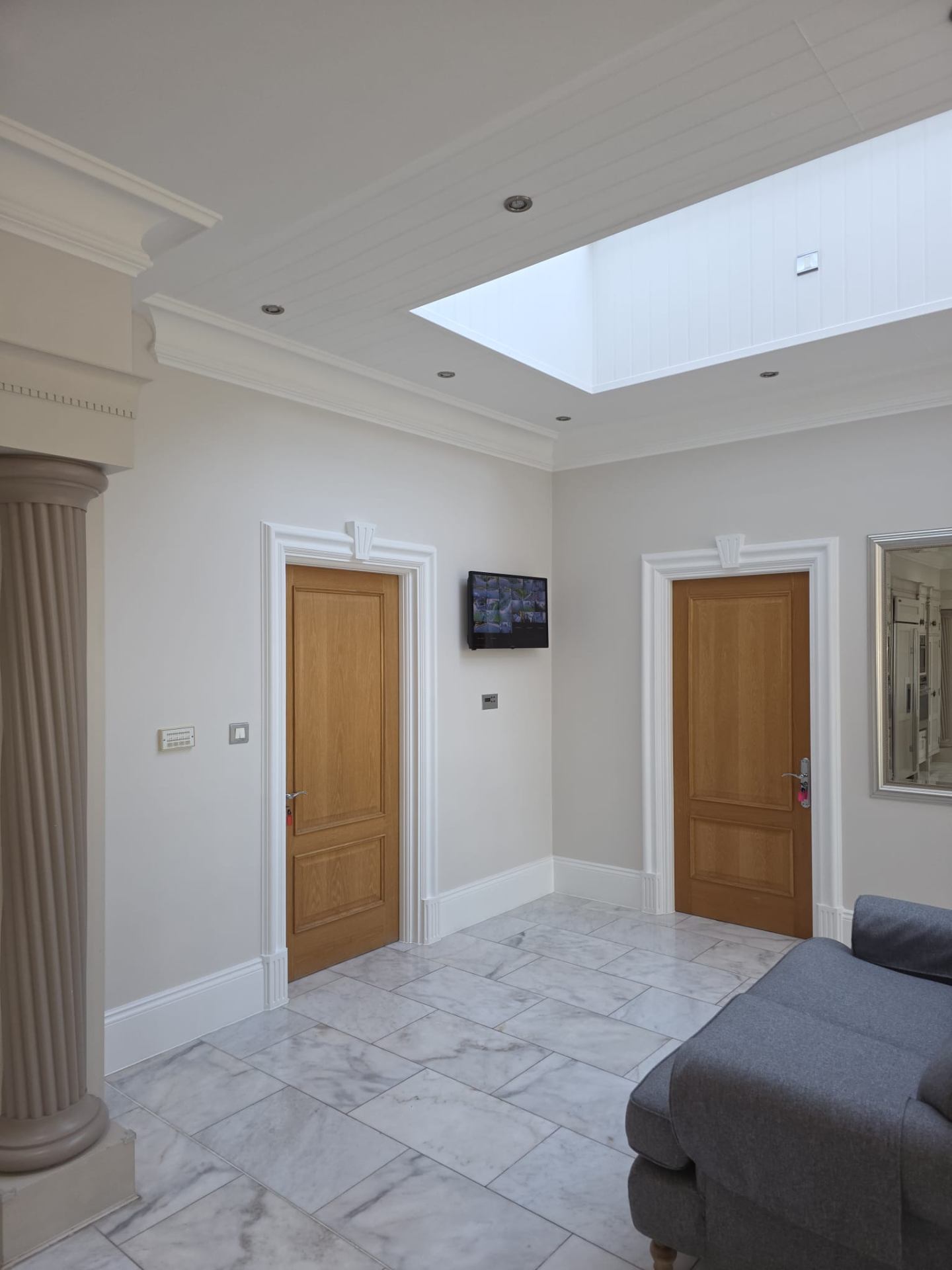 Grand entrance hall with restored woodwork, oak doors and marble flooring