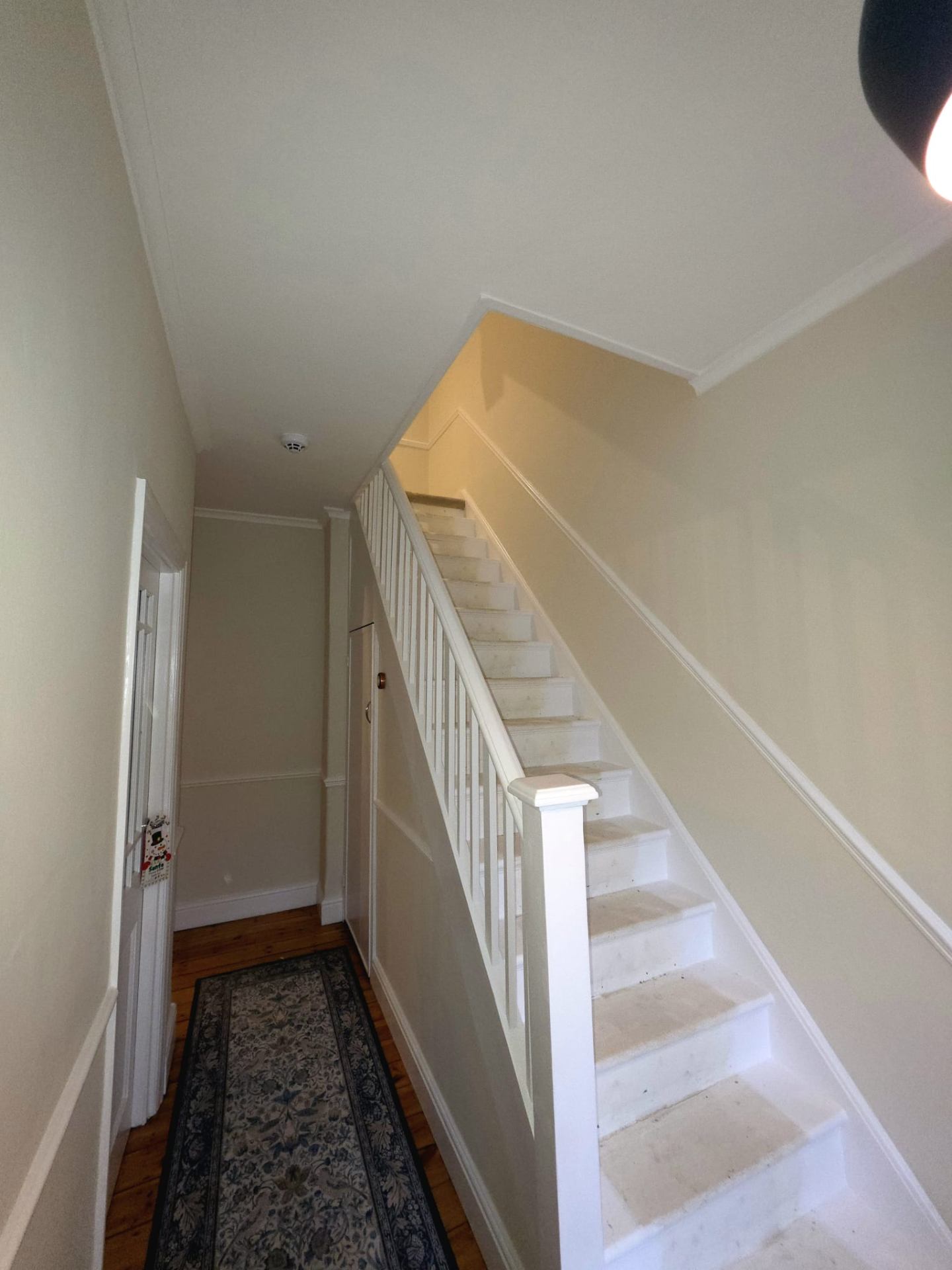 Freshly painted white hallway and staircase by Shreeve and Sons painters and decorators in South London