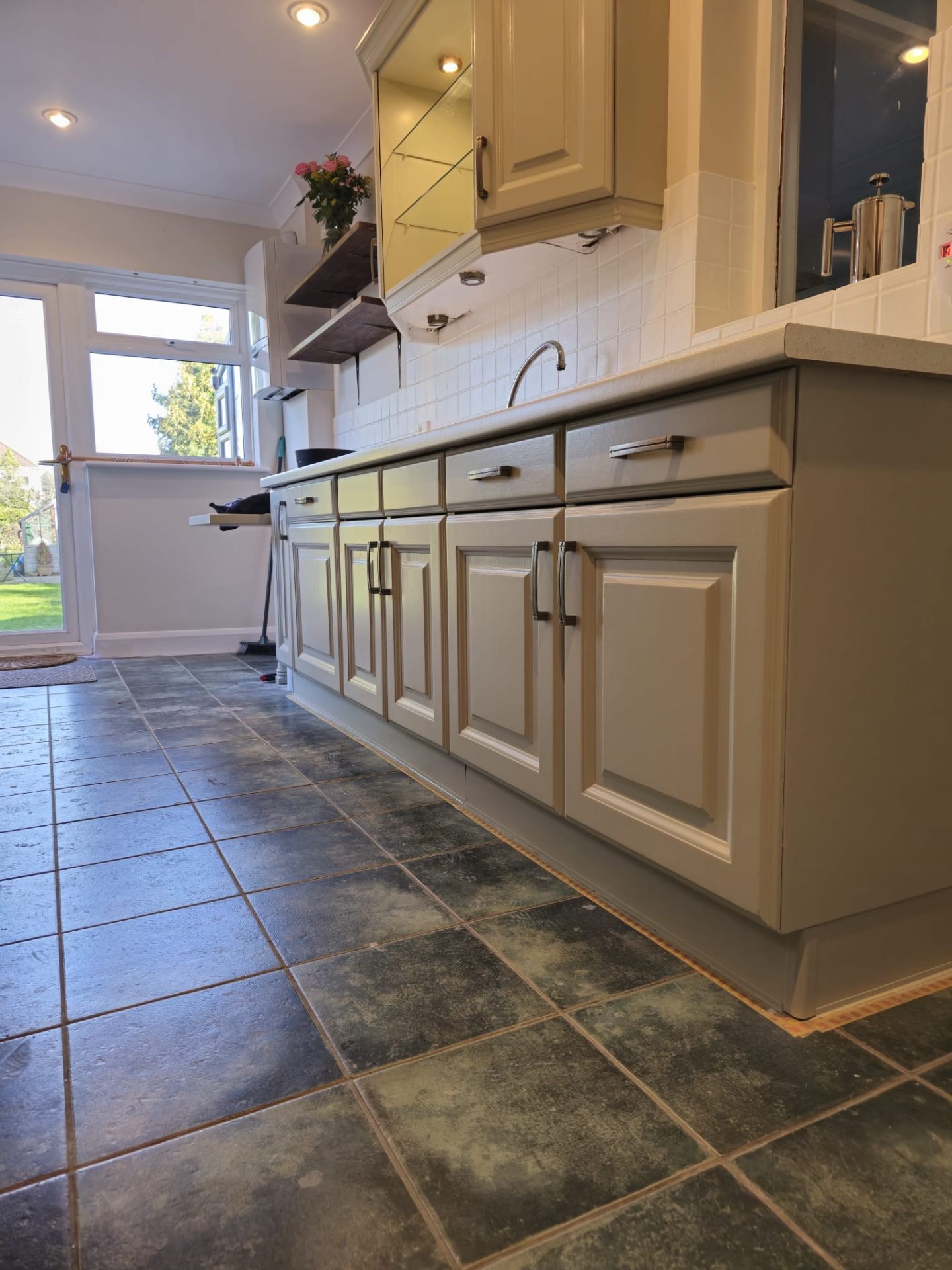 Full kitchen with cream spray painted cabinets and fitted appliances