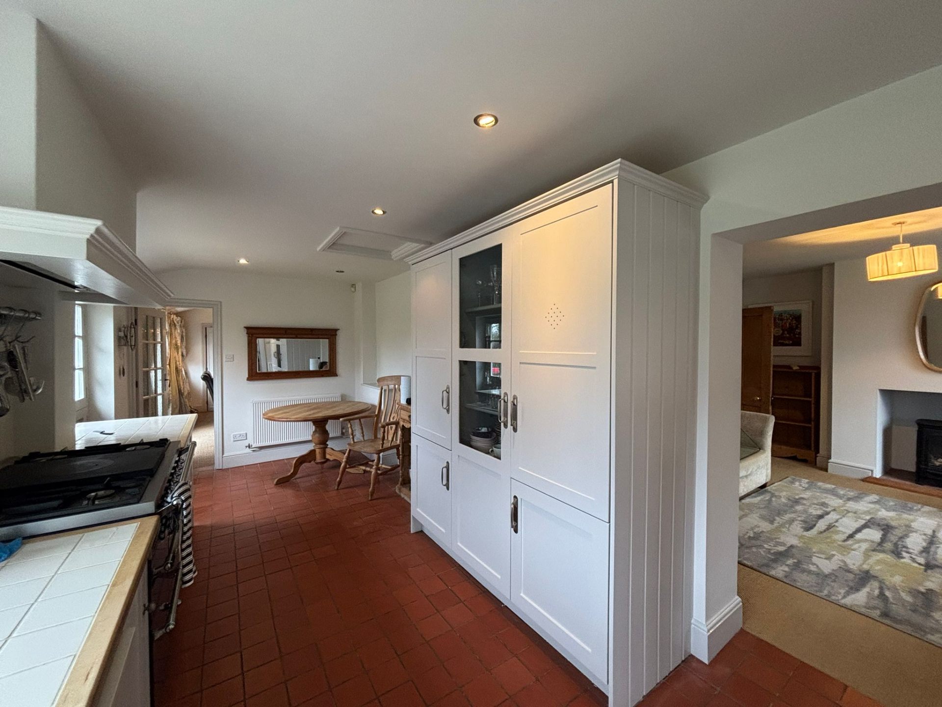 Hand painted white kitchen pantry unit in a Surrey family home