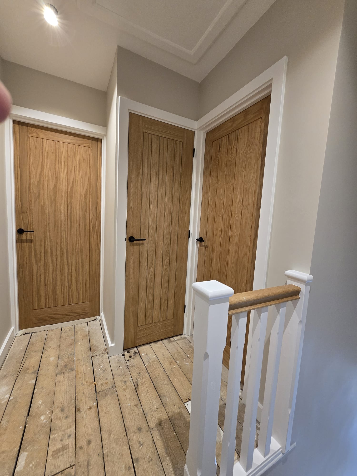 Landing with restored oak doors and white painted frames