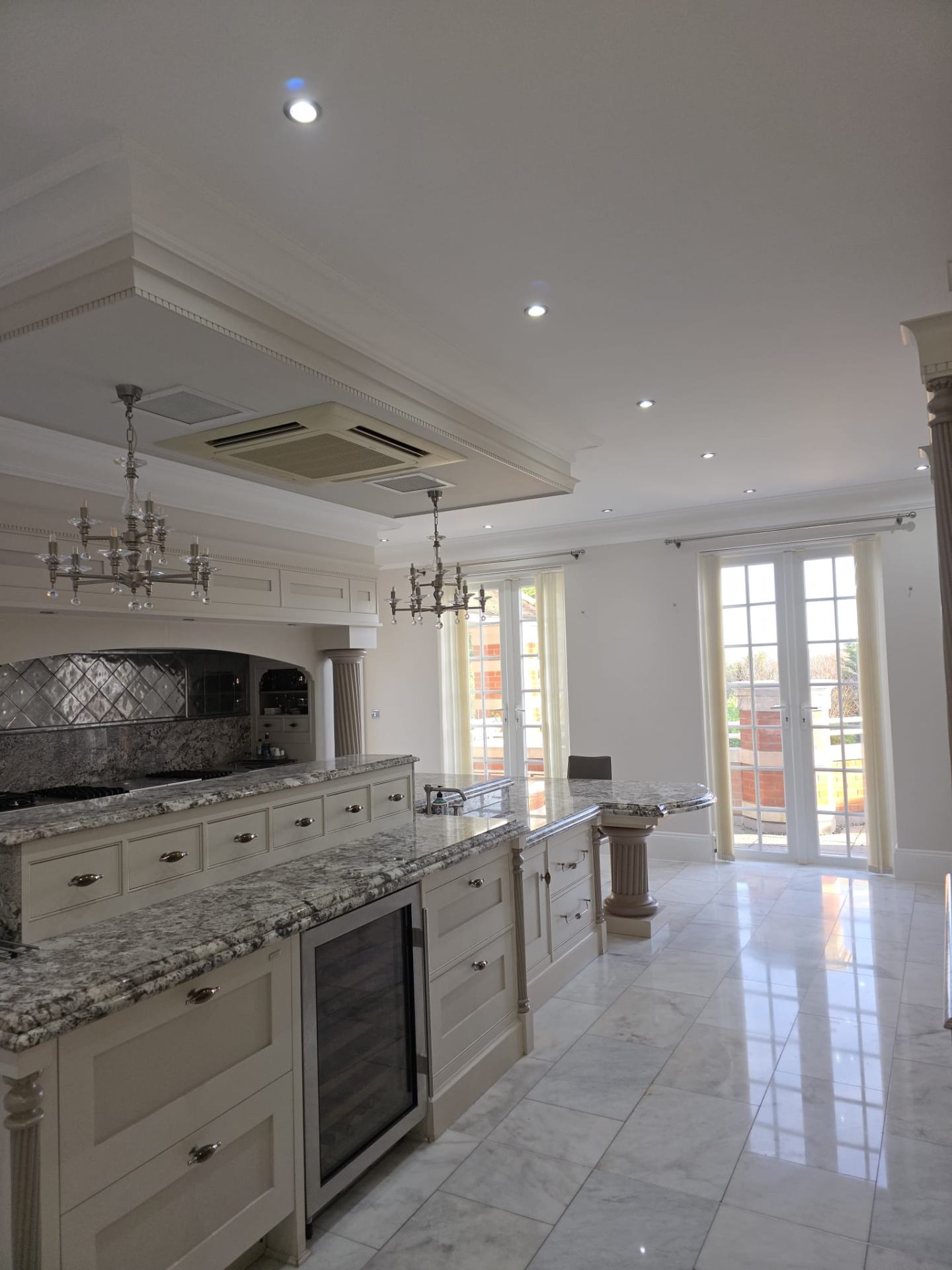 Luxury hand painted kitchen with marble countertops and period detailing