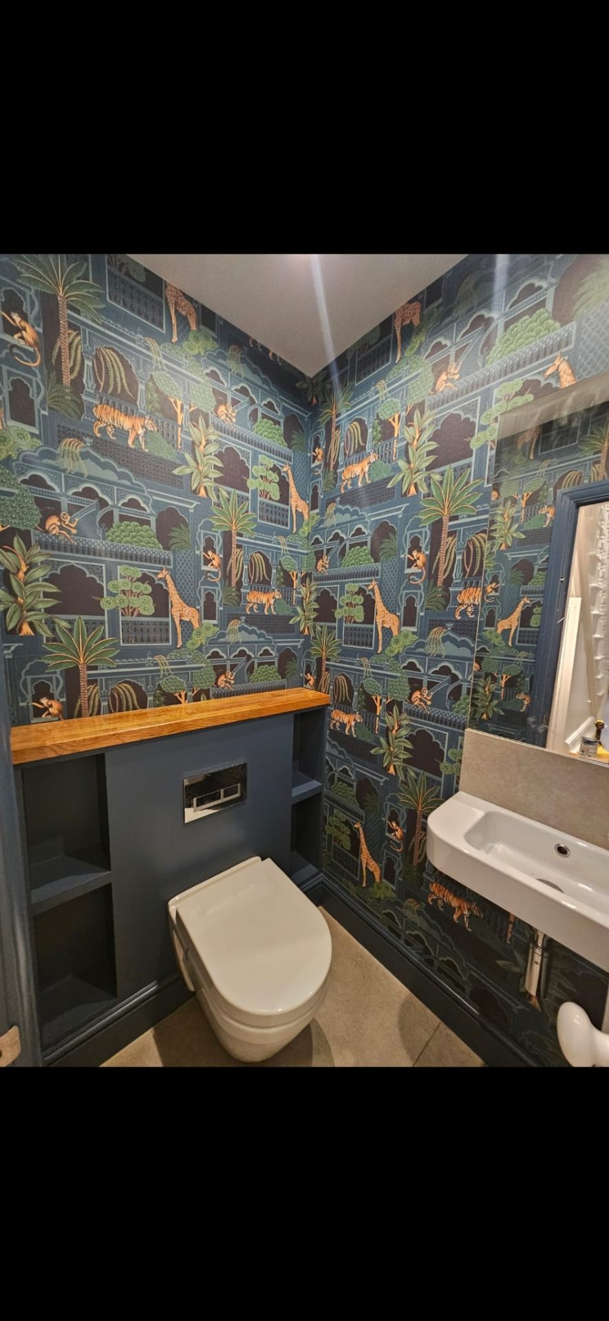 Full downstairs WC wallpapered in tiger and giraffe jungle pattern by Shreeve and Sons